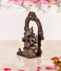Copper Ganesha murti idol statue, side view with decorative arch backdrop