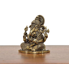 Superfine Brass Lord Ganesha idol, side view, seated posture with raised hands, 2-inch height.