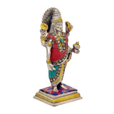 Dhanvantari brass statue, side view; red robe and teal sash with detailed circular ornaments.