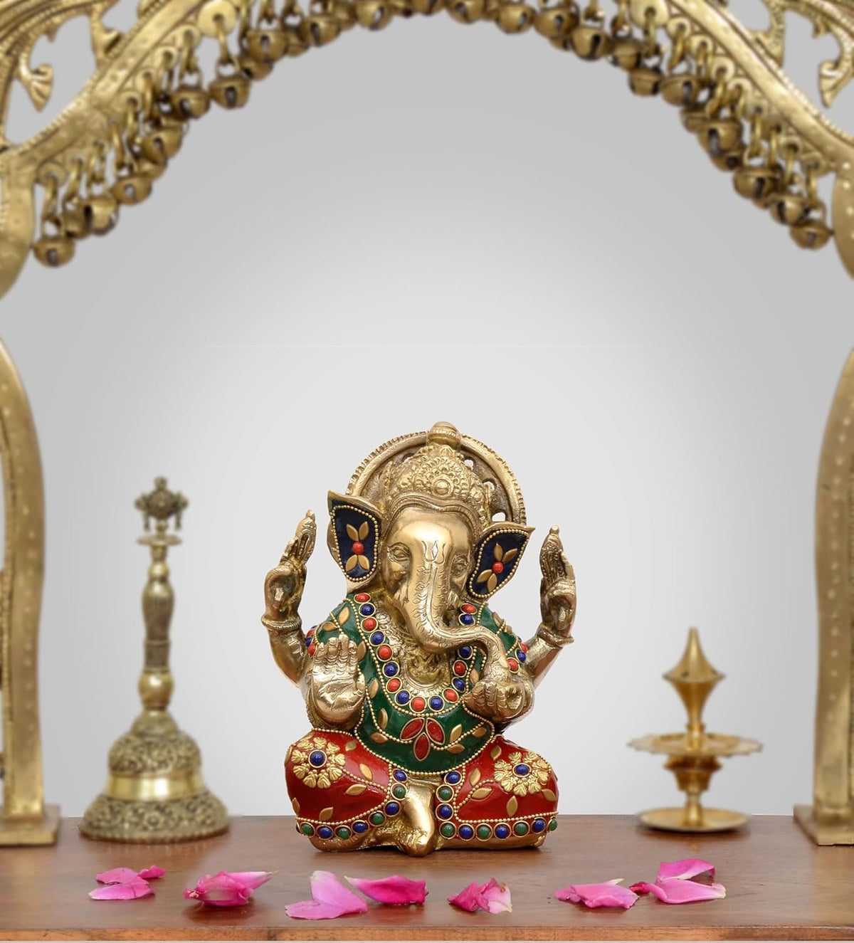 Brass Lord Ganesha idol in seated pose, gold finish with blue-red gemstone-style accents