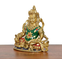 Seated Kubera statue with green jeweled robe, gold face, and ornate arm details