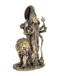 Durga Maa brass statue holding trident and weapons, lion companion at the feet
