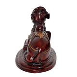 Back view of seated Nandi bull statue, dark brown glossy finish with gold trim