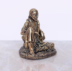 Shirdi Sai Baba brass statue, side view with crossed-leg seated posture and arm details