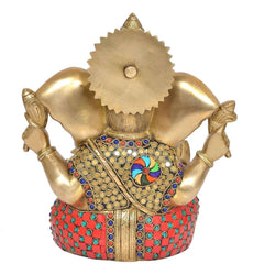 Rear view of brass Ganesha idol with jeweled belly and crown, studded circular pattern