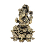 Ganesha brass idol side view with detailed trunk, jewelry, and lotus petals