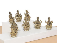 Side view of eight brass Ashtalakshmi goddess statues with raised hands and lotuses