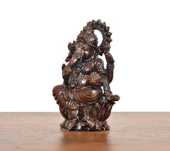 Side view of Lord Ganesha brass idol, seated with detailed ornaments and draped cloth