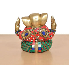 Brass Ganesha sculpture back view, multicolor patterned garment and jeweled round medallions