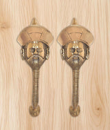 Two brass man-face door handles with turban head and detailed beard