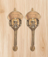 Two brass man-face door handles with turban head and detailed beard