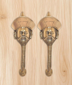 Two brass man-face door handles with turban head and detailed beard