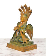 Brass naga kanya statue, side view: seated goddess with tall crown and wing details