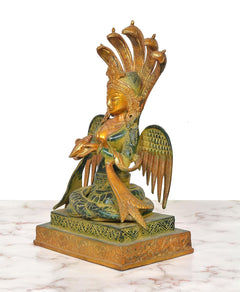 Brass naga kanya statue, side view: seated goddess with tall crown and wing details