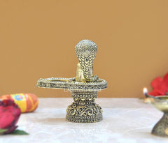 Front view brass shivling with cobra hood, engraved pedestal, standing figurine.