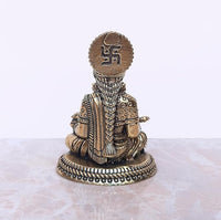 Brass Maa Annapurna murti, back view with engraved design on the head panel
