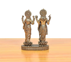 Back view of bronze Lakshmi and Vishnu idol, detailed crowns and garments