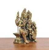 Brass Shiva family idol side view, seated with trident and attendant figures