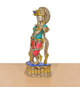 Side view Krishna flute idol sculpture; brass figure with blue top and red patterned dhoti