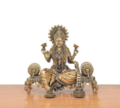 Lakshmi Maa seated on singhasan, raised hands, detailed crown and jewelry