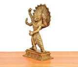 Brass Narasimha statue, side profile with flared fan-like headdress and raised right arm