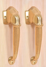Brass door handle pair with ornate Ganesha face motif on wall plates, golden finish