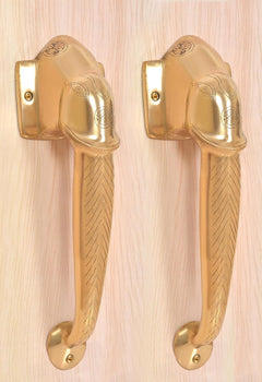 Brass door handle pair with ornate Ganesha face motif on wall plates, golden finish