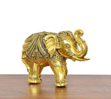 Golden brass elephant decor figurine, front-right view with trunk curled upward