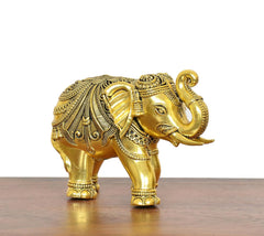 Golden brass elephant decor figurine, front-right view with trunk curled upward