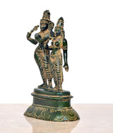 Side view brass Shiva-Parvati dancing idols with ornate patterns, round base
