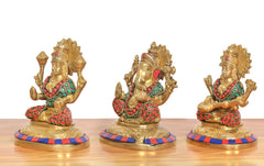 Side view of brass Lakshmi, Ganesh and Saraswati idols with painted beads and round bases