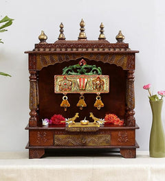 Brown wooden mandir with hanging Balaji idol panel and three gold bells