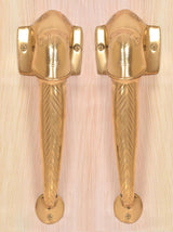 Golden brass Ganesha face door handles with square wall plates and chevron lever grip