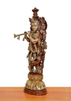 Krishna brass flute sculpture, angled side view with ornate back ornaments and flute raised
