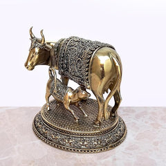 Brass cow and calf pooja mandir decor, side view of ornate back panel and stand
