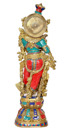 Brass Radha idol statue with round halo behind, red skirt and teal accents on gold base