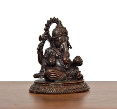 Lord Ganesha murti angled view, multiple arms and ornate pedestal base