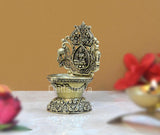 Brass Laxmi diya with sculpted deity niche and decorative base, 4-inch height