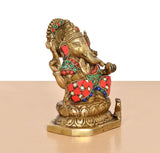 Brass Ganesha statue angled view, ornate beadwork and red skirt with gemstone-like inlays