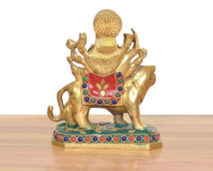 Rear view Durga Maa brass statue on lion, multicolor gemstone-like trim around the base