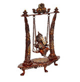 Brass Ganesha swing idol angled view, four pillars and hanging frame