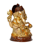 Rear-quarter view of gold brass Ganesha statue with dark crown and orange details