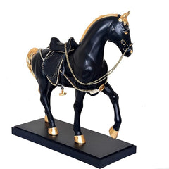 Rear three-quarter view: black royal horse figurine with golden mane, bridles, chains.