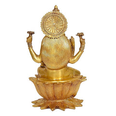 Rear view of brass Lakshmi statue, circular halo emblem over lotus pedestal
