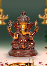Ganesha idol with four arms, seated on ornate base, 14-inch height