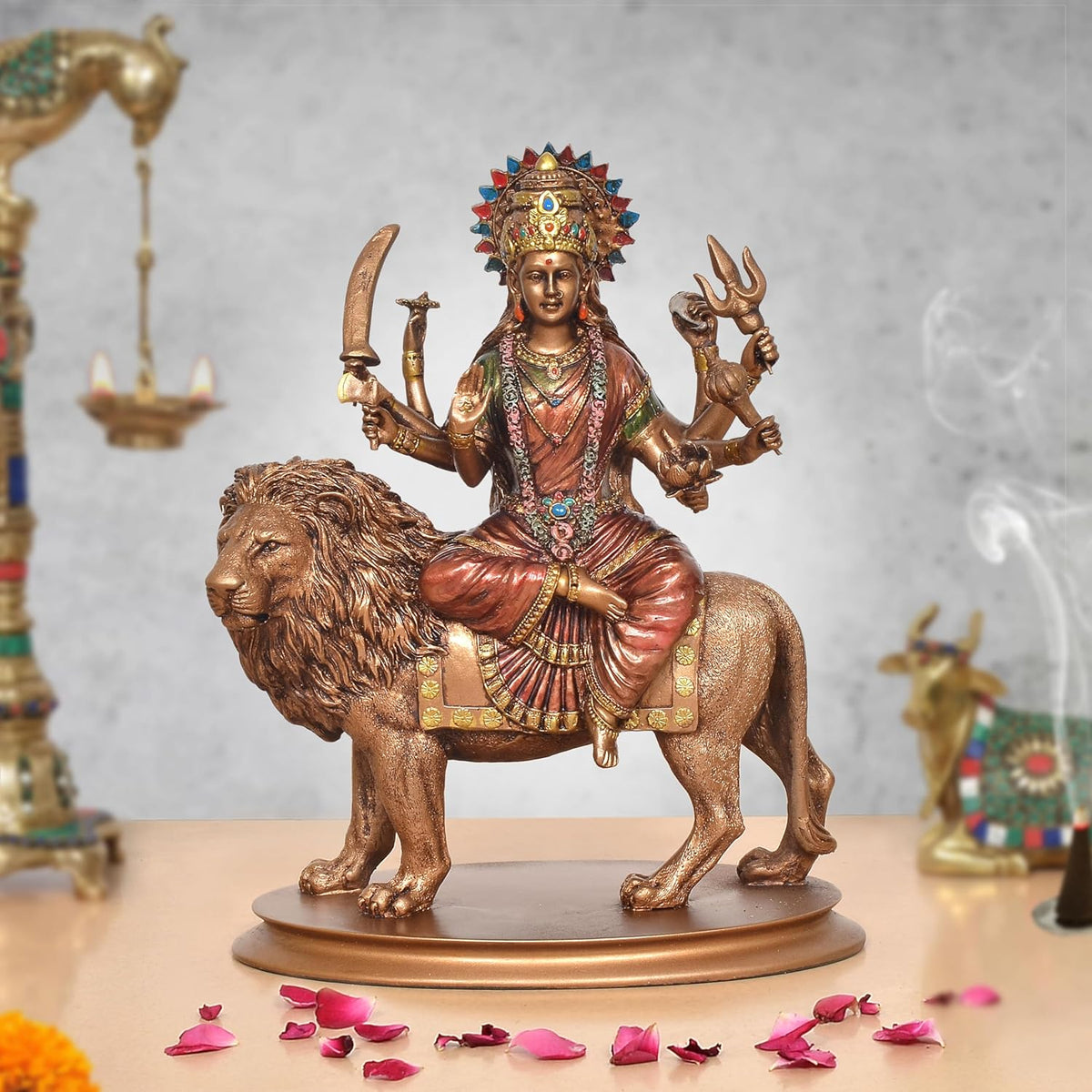 Durga Maa resin idol on lion, jeweled crown, four arms holding symbols