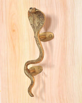 Brass snake door handle with head detail and two golden oval backplates