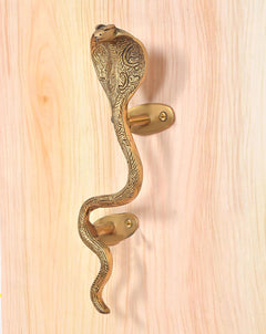 Brass snake door handle with head detail and two golden oval backplates