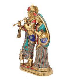 Brass Radha-Krishna idol, side view; Krishna holds flute, Radha draped veil