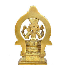 Back view of golden Mariamma idol statue with circular halo arch and crown details